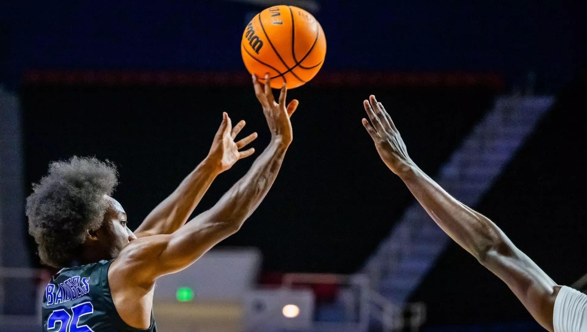 Walter Peggs shoots a three-pointer for Spring Hill College.