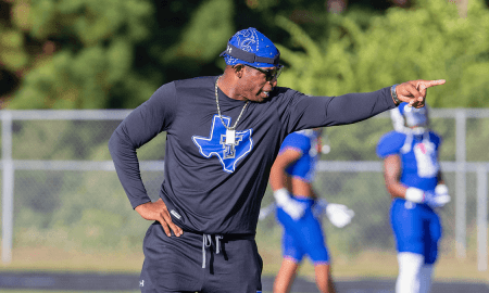 Deion Sanders on the sidelines coaching High School