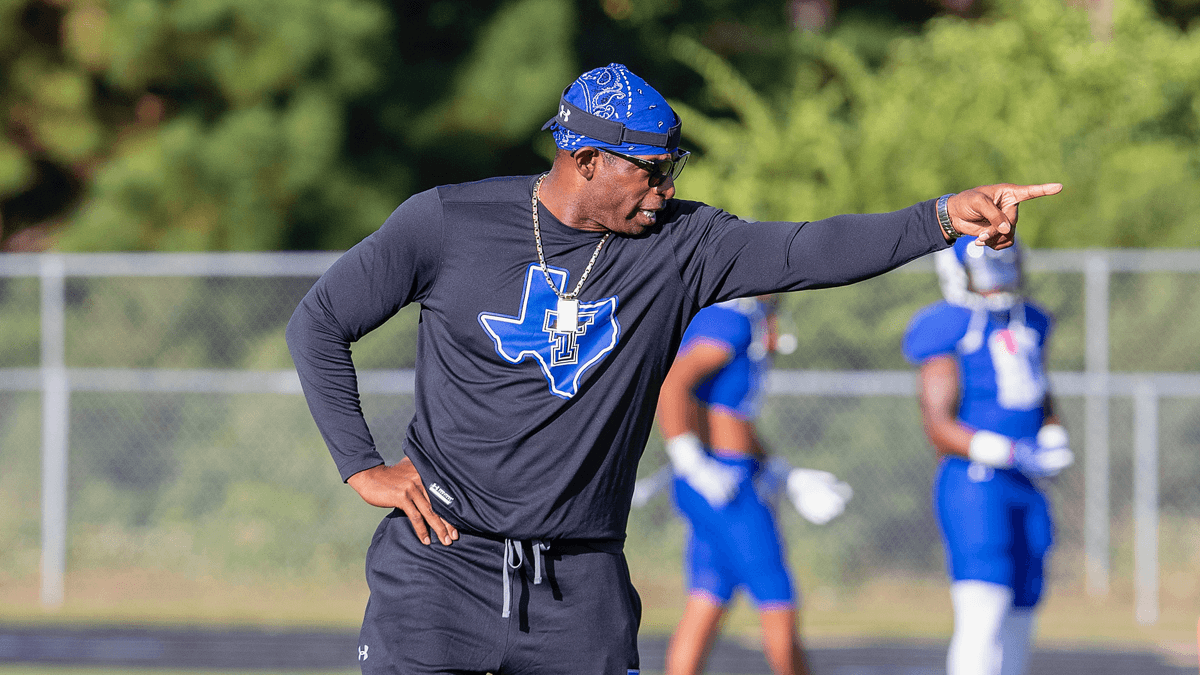 Deion Sanders on the sidelines coaching High School