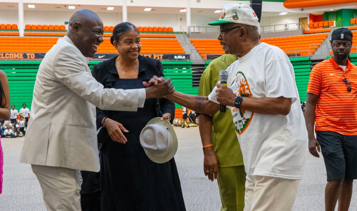 Attorney Ben Crump (left) greets former FAMU band director Dr. Julian White.