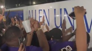 HBCU football team bus surrounded by opponents after game