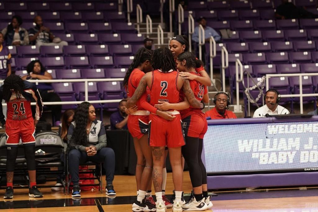 JSU women's basketball in red uniforms.