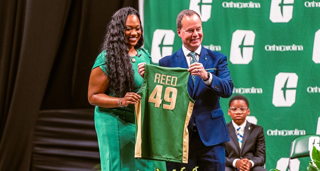 Tomekia Reed, the former Jackson State coach, is presented with a Charlotte jersey at her introductory press conference.