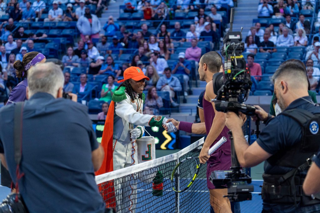 FAMU head drum major Oluwamodupe Oloyede greets U.S. Open men's favorite Carlos Alcaraz.