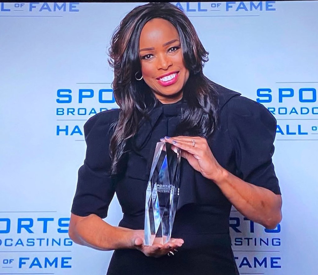 NFL reporter Pam Oliver poses with her award for the Sports Broadcasters Hall of Fame.