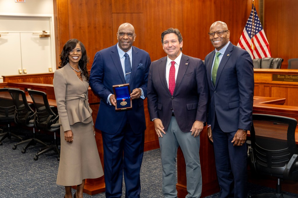 Andre Dawson Is Flankedu By PResident Marva Johnson Governor Ron DeSantis And AD John Davis